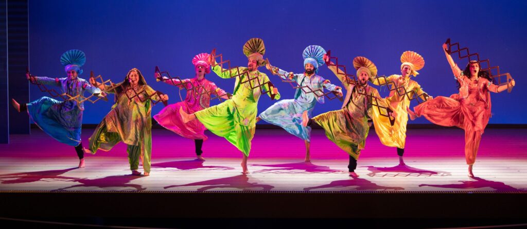 Men & Women dancing in colorful costumes
