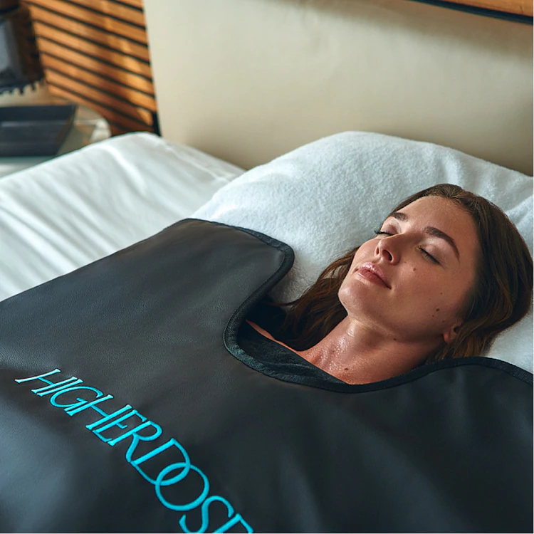 Infrared sauna blanket with woman inside